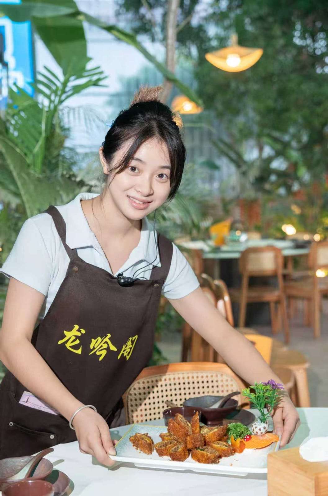 Restaurant staff serving a dish in the garden restaurant