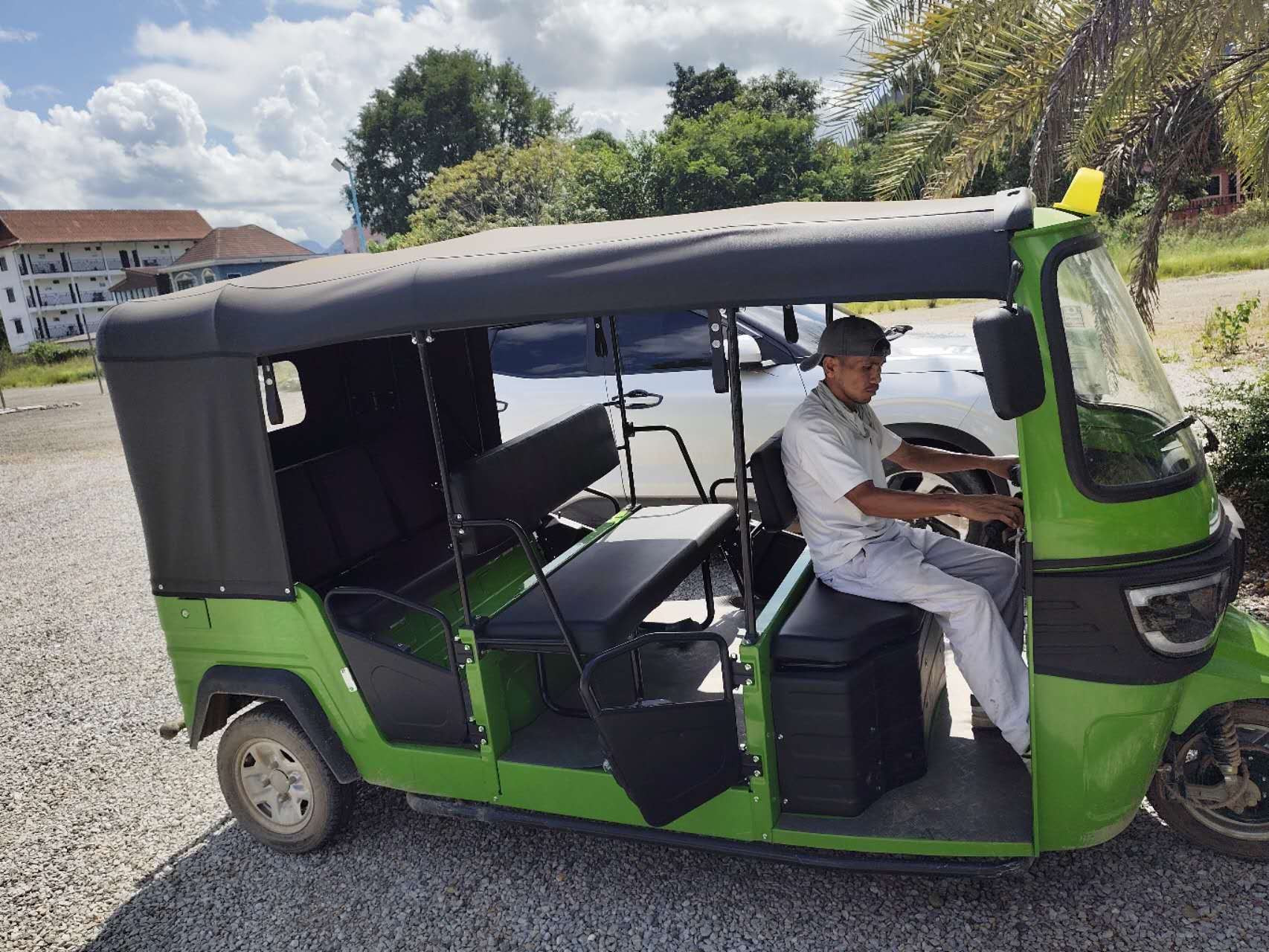 Green tuk-tuk used for pick-up and drop-off at Vang Vieng Elephant Experience