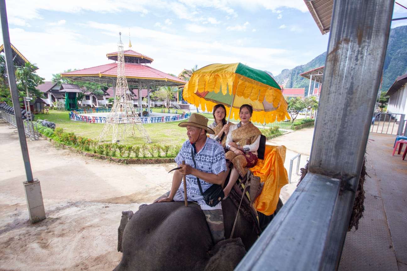 Visitors with a mahout during an elephant experience in Vang Vieng, Laos