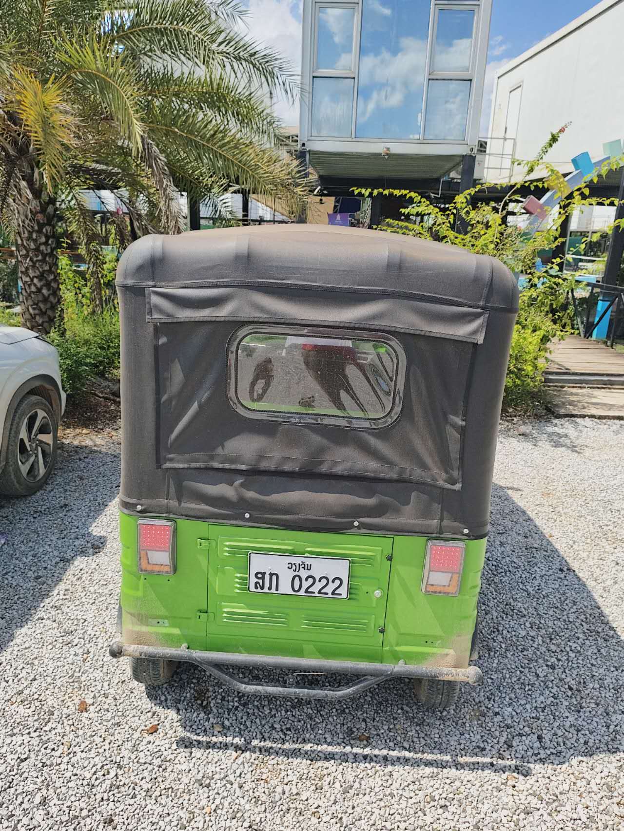 Green tuk-tuk used for pick-up and drop-off at Vang Vieng Elephant Experience
